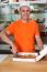 Male Chef Slicing Pizza Into Pieces