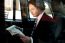 Man Reading Newspaper Inside Taxi Cab