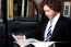 Businessman Reading Magazine Inside Taxi