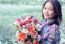 Young Woman Holding Artificial Flower Bouquet