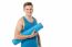 Male Gym Instructor Holding Blue Mat