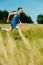 Young Man Running Through Meadows