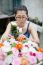 Woman Arranging Artificial Flower In Wood Box