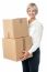 Middle Aged Woman Moving Packed Boxes