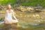 Beautiful Woman Practive Yoga On River In Nature