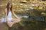 Beautiful Woman Practive Yoga On River In Nature