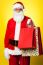 Joyous Santa Posing With Colorful Shopping Bags