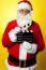 Cheerful Kris Kringle Posing With Clapperboard