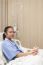 Girl Lying On Patient Bed On Hospital Treatment Room Waiting For