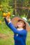 Gardener Girl Picking Fresh Orange