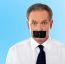 Businessman With Tape On His Mouth