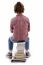 Back Pose Of Boy Sitting On Books