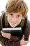 High Angle View Of Smiling School Boy Looking At Camera