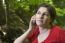 Woman In Forestry And Mobile Phone