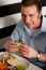 Man Eating Sandwich In A Restaurant