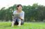 Woman Holding Tablet In Park