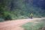 Lonely Cyclist Biking Mountain Bike On Dusty Road