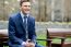 Smiling Businessman Relaxing On Park Bench