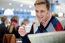 Smiling Man Reading Newspaper At Restaurant