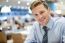 Smiling Young Man Relaxing In Restaurant