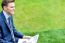 Businessman Reading Newspapers In Park