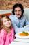 Little Girl With Her Father In Restaurant