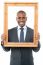 Smiling Businessman Looking Through Picture Frame