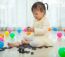 Little Girl Playing With Black Domino