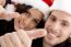 Close Up View Of Young Couple Wearing Christmas Hat And Looking At Camera