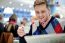 Smiling Man Reading Newspaper At Restaurant