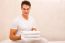 Smiling Young Man Holding Stack Of Towels