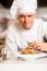 Chef Arranging Pasta Salad In A White Bowl