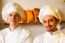 Young Smiling Chefs Posing In Bakery