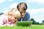 Two Children Lying Down And Using Tablet Pc