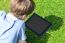 Young Boy Using Digital Tablet Outdoors