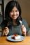 Young Beautiful Woman With A Cake In Cafe