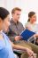 Confident Businessman Sitting With His Colleagues In Office