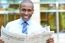 Smiling Executive Holding Newspaper