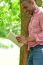 Smiling Man Using Tablet Pc In The Park