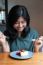 Beautiful Asian Woman Prepare To Eating A Cake In Cafe