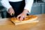 Male Chef Cutting Bread Loaf