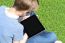 Boy With Touch Pad Sitting On Meadow