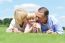 Smiling Couple With Daughter Posing At Outdoors