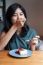 Young Woman Enjoy With A Cake In Cafe