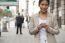 Young Woman And Smart Phone Walking On Street