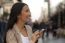 Young Woman Using A Phone Outside  Of Office