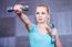 Strong Young Woman Exercising With Dumbbells At The Gym