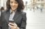 Woman With Cellphone Walking On Street