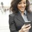 Young Businesswoman With Smartphone Walking On City