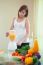 Young Woman Making Fruit Smoothie In Blender